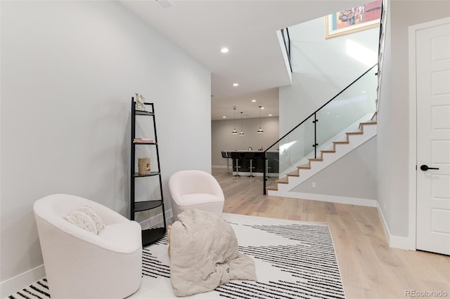 interior space featuring stairs, baseboards, wood finished floors, and recessed lighting