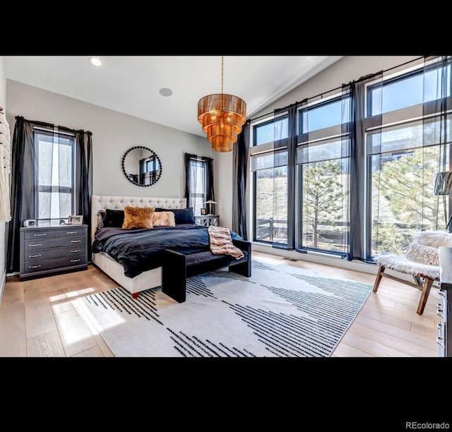 bedroom with vaulted ceiling, light wood finished floors, and recessed lighting