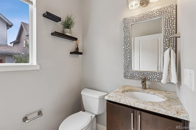 half bathroom featuring toilet and vanity
