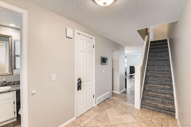 interior space featuring sink and a textured ceiling