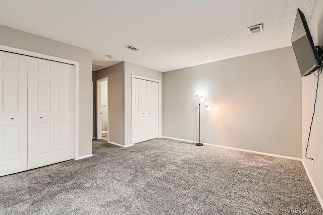 unfurnished bedroom featuring carpet and a textured ceiling