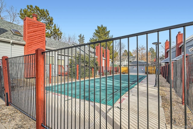 view of swimming pool featuring an outbuilding and a patio area