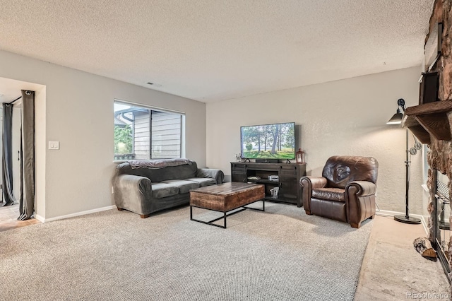 living area featuring a textured ceiling, light colored carpet, and baseboards