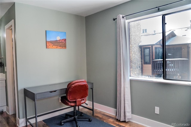 office space with wood finished floors and baseboards