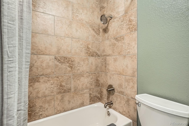 full bath featuring a textured wall, shower / bathtub combination with curtain, and toilet