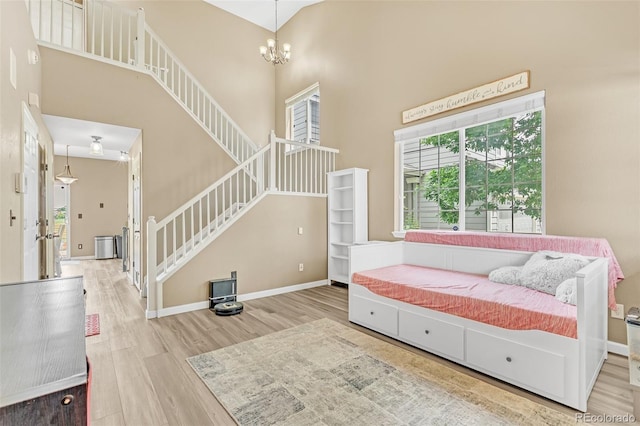 19463 E Hollow Creek Dr, Parker, CO 80134 - living area featuring stairs, a towering ceiling, wood finished floors, and a chandelier
