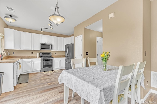 19463 E Hollow Creek Dr, Parker, CO 80134 - dining space featuring light wood-style floors and baseboards