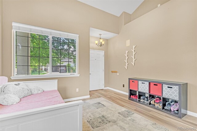 19463 E Hollow Creek Dr, Parker, CO 80134 - bedroom with wood finished floors and a chandelier