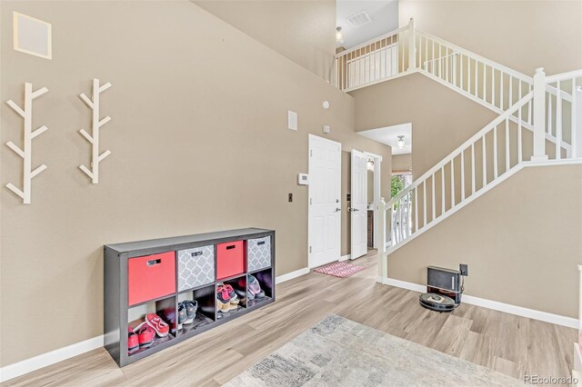 19463 E Hollow Creek Dr, Parker, CO 80134 - foyer featuring wood finished floors, stairway, and a high ceiling