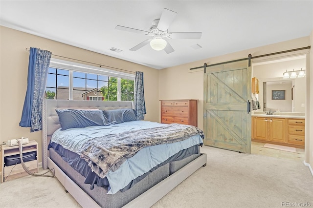 19463 E Hollow Creek Dr, Parker, CO 80134 - bedroom with a barn door, light colored carpet, ceiling fan, and connected bathroom