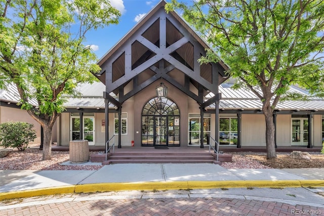 19463 E Hollow Creek Dr, Parker, CO 80134 - doorway to property with a standing seam roof, french doors, a metal roof, and a porch