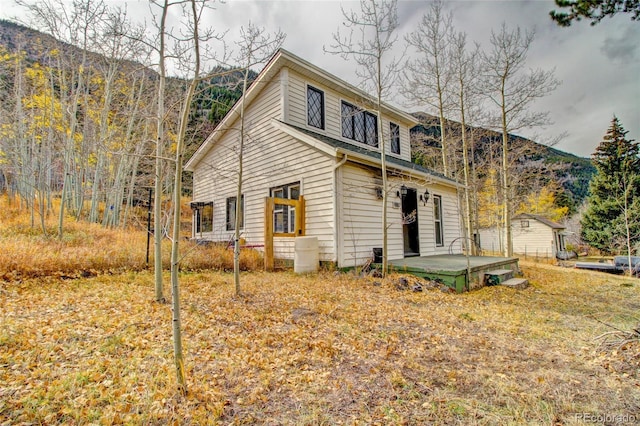 back of house with a mountain view