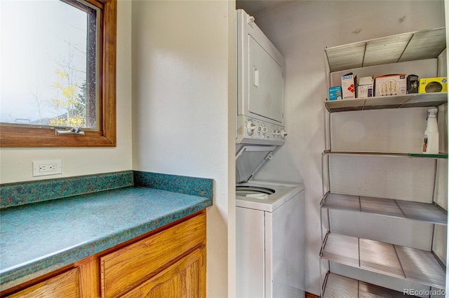 laundry area with stacked washer and dryer