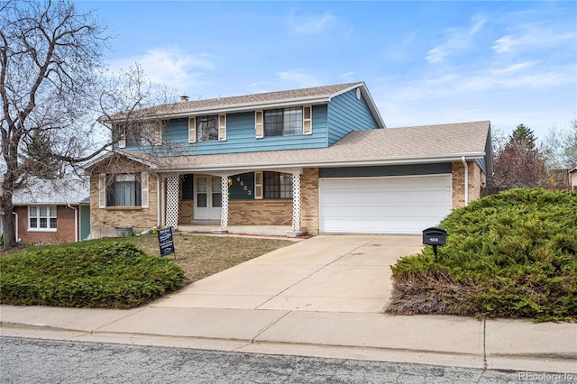 traditional home with a garage, brick siding, driveway, and a shingled roof