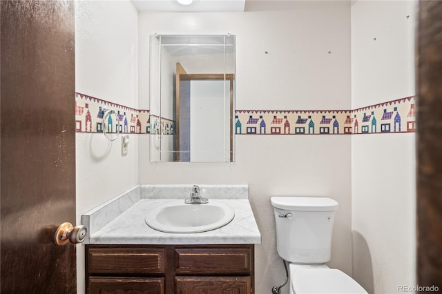 half bathroom featuring toilet and vanity