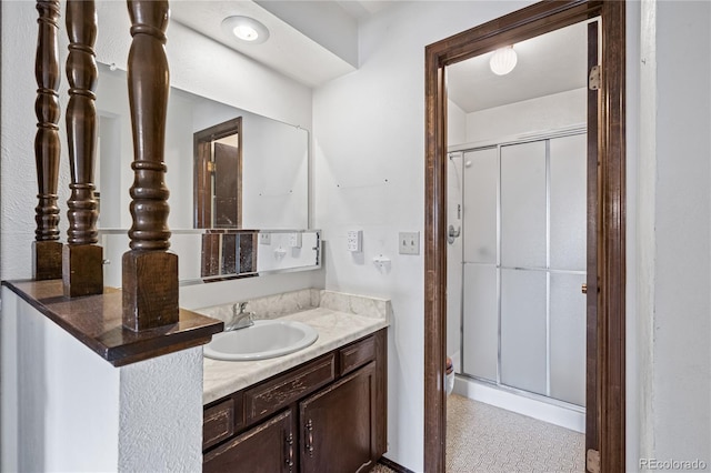 bathroom featuring a shower stall and vanity