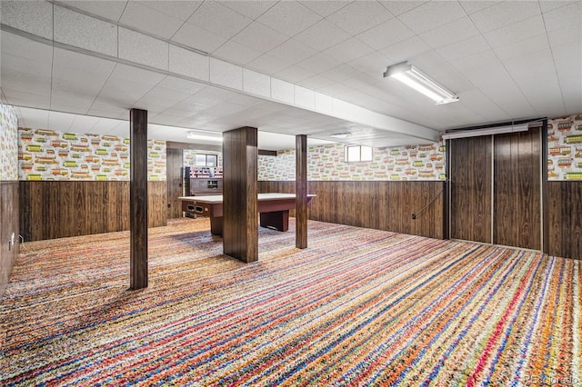 basement with carpet flooring, wooden walls, wainscoting, and billiards