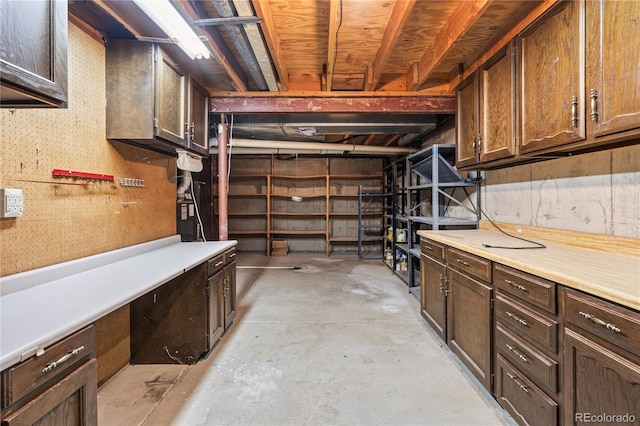 unfinished below grade area featuring a workshop area
