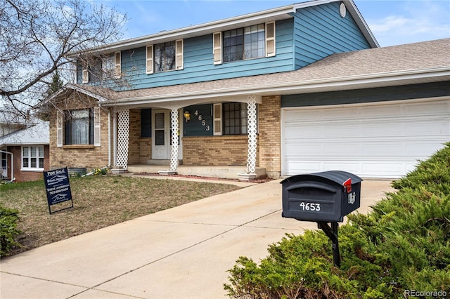 traditional-style home with concrete driveway, a garage, and brick siding