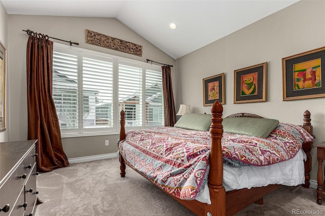 bedroom featuring lofted ceiling and light carpet