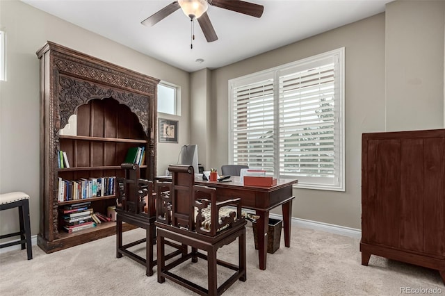 office featuring ceiling fan and light carpet