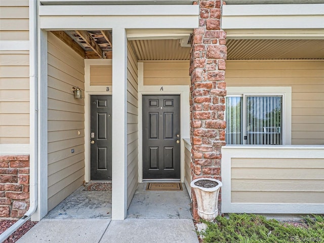 view of exterior entry with covered porch