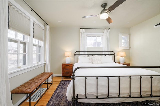 bedroom featuring visible vents, baseboards, and light wood-style floors