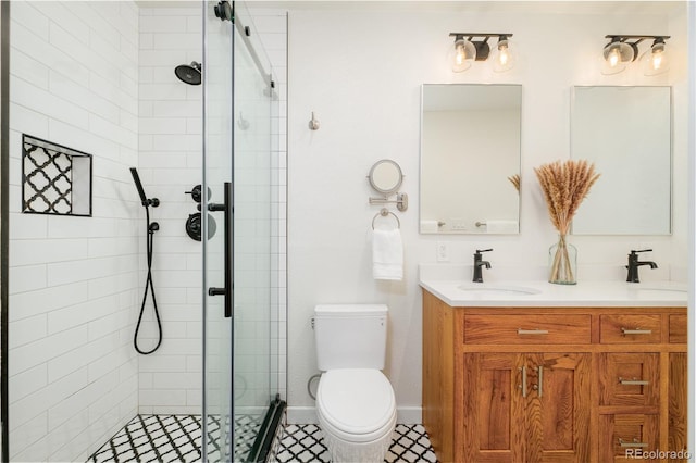 bathroom featuring a sink, toilet, a stall shower, and double vanity