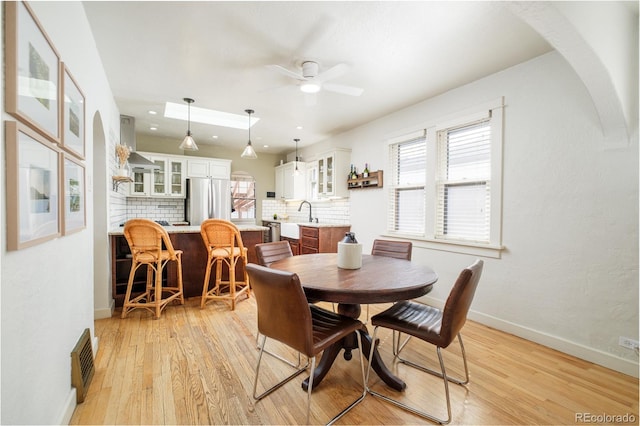 dining area with visible vents, a healthy amount of sunlight, and light wood-style flooring