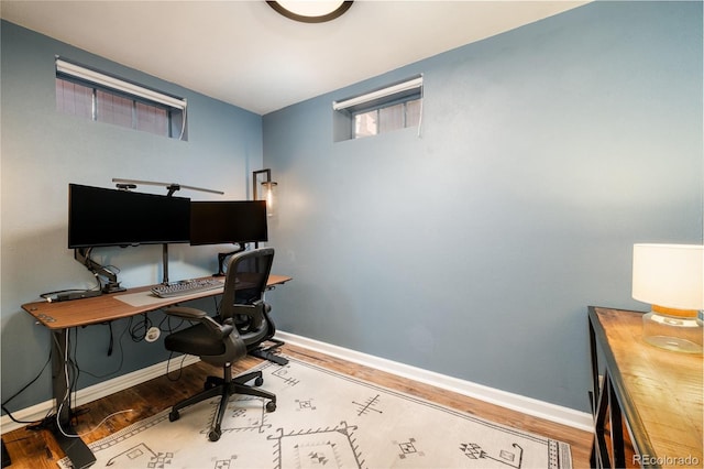 home office featuring baseboards and wood finished floors