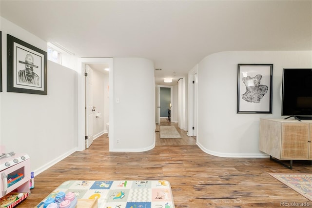 interior space featuring baseboards and wood finished floors