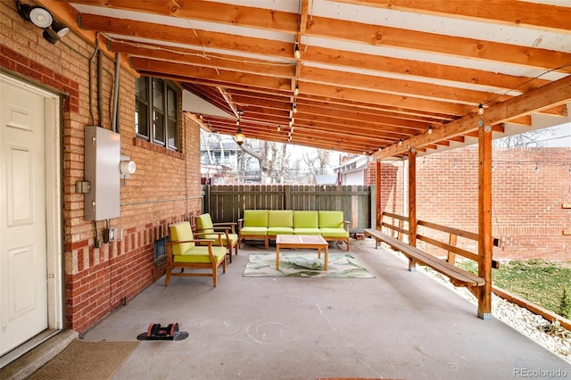 view of patio / terrace featuring an outdoor living space and fence