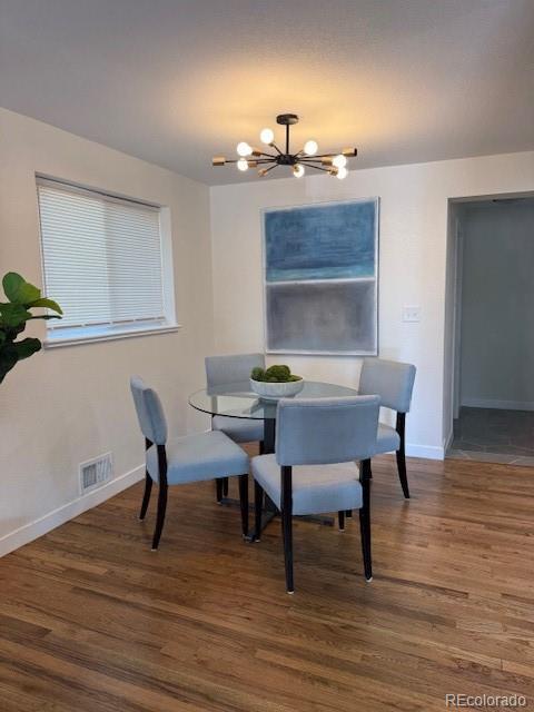 2510 Kenton, Aurora, CO 80010 - dining area with a chandelier and wood finished floors