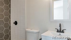 2510 Kenton, Aurora, CO 80010 - bathroom featuring vanity and a tile shower