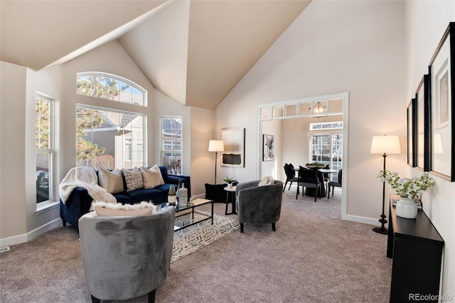 carpeted living room featuring a wealth of natural light and a high ceiling