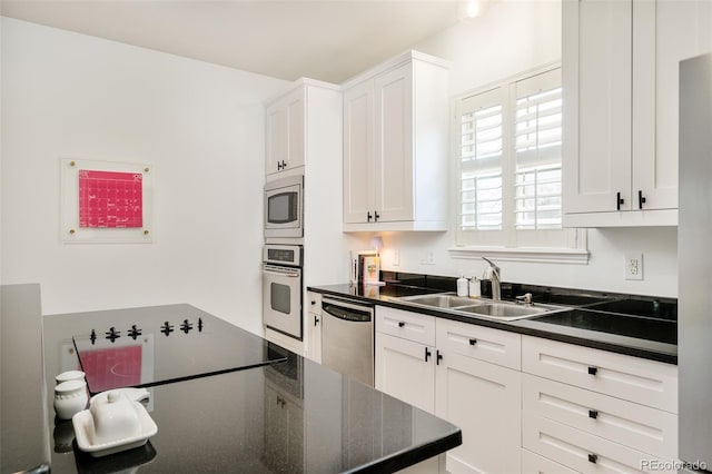 kitchen featuring sink, stainless steel appliances, and white cabinets