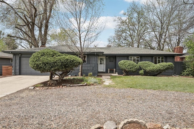 single story home with concrete driveway, a garage, a chimney, a front yard, and a shingled roof