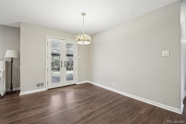 unfurnished dining area featuring french doors, baseboards, and dark wood-type flooring