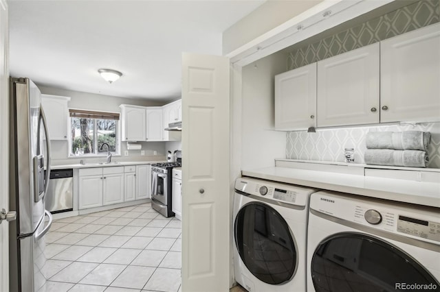 washroom with washer and clothes dryer and light tile patterned floors