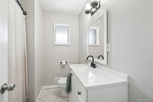 full bathroom featuring toilet, vanity, and tile patterned floors