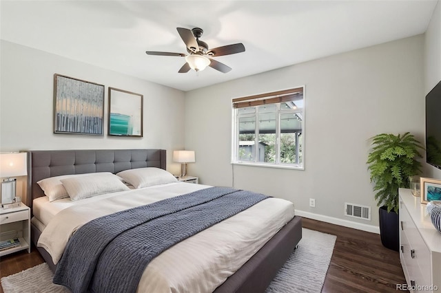 bedroom with baseboards, dark wood finished floors, and ceiling fan