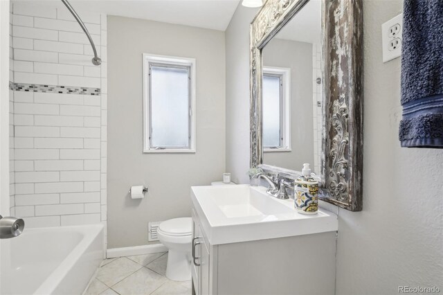 bathroom featuring toilet, tile patterned flooring, vanity, baseboards, and  shower combination