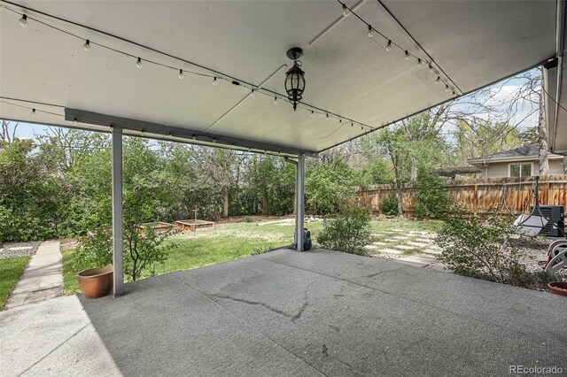 view of patio / terrace featuring view of wooded area