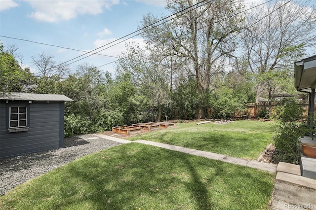 view of yard with a garden and an outdoor structure