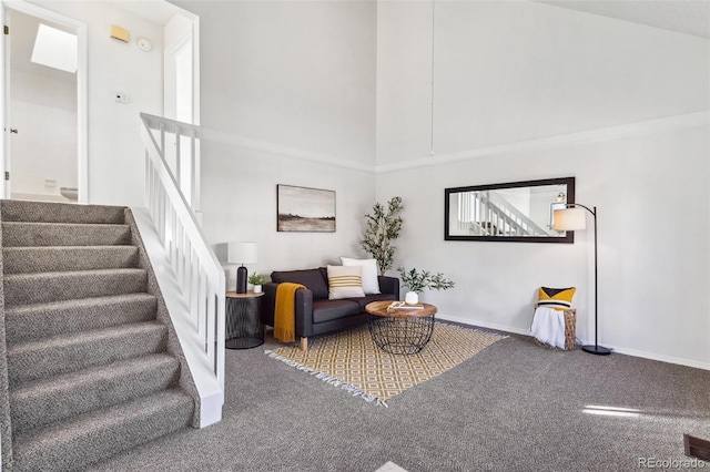 carpeted living room featuring a high ceiling