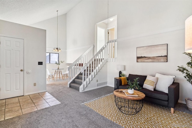 tiled living room featuring a chandelier and high vaulted ceiling