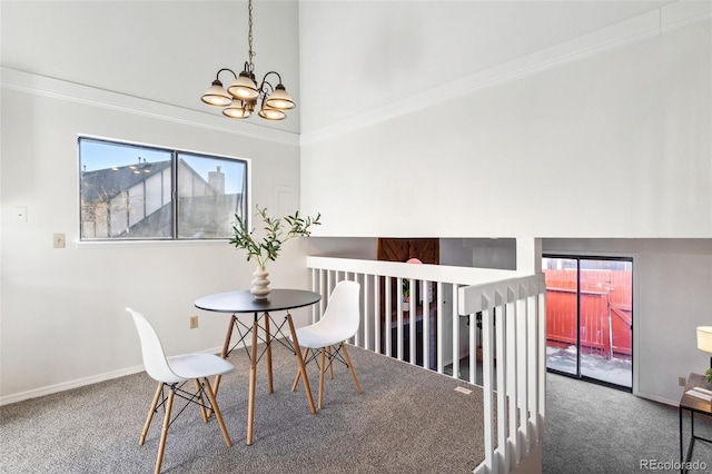 dining area with a high ceiling, crown molding, an inviting chandelier, and carpet flooring