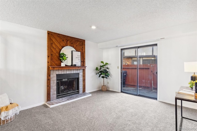 unfurnished living room with carpet floors, a textured ceiling, and a brick fireplace