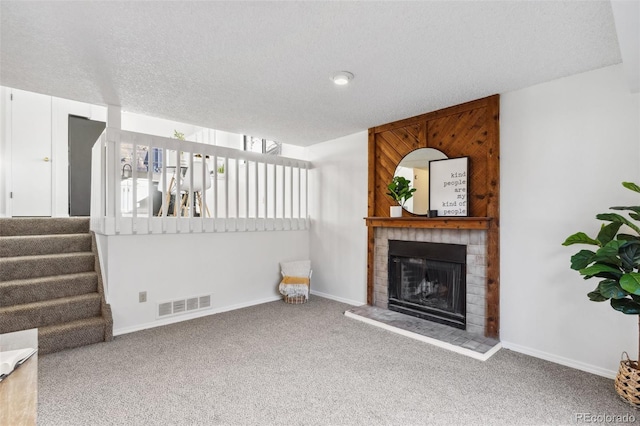 carpeted living room featuring a textured ceiling