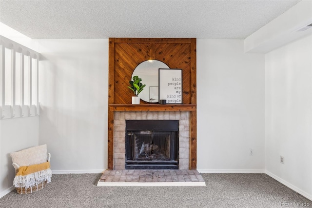 living room featuring a fireplace, a textured ceiling, and carpet flooring